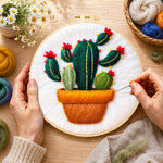 Creating the potted cactus with red flowers wool painting by hand with a felting needle