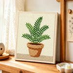 Potted green fern punch needle artwork displayed on a table