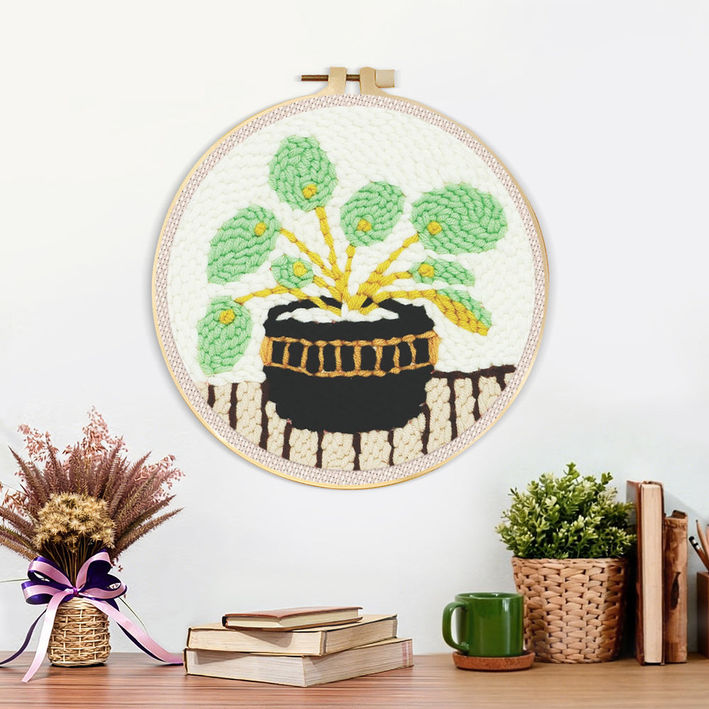 Finished potted green plant artwork displayed on a wall
