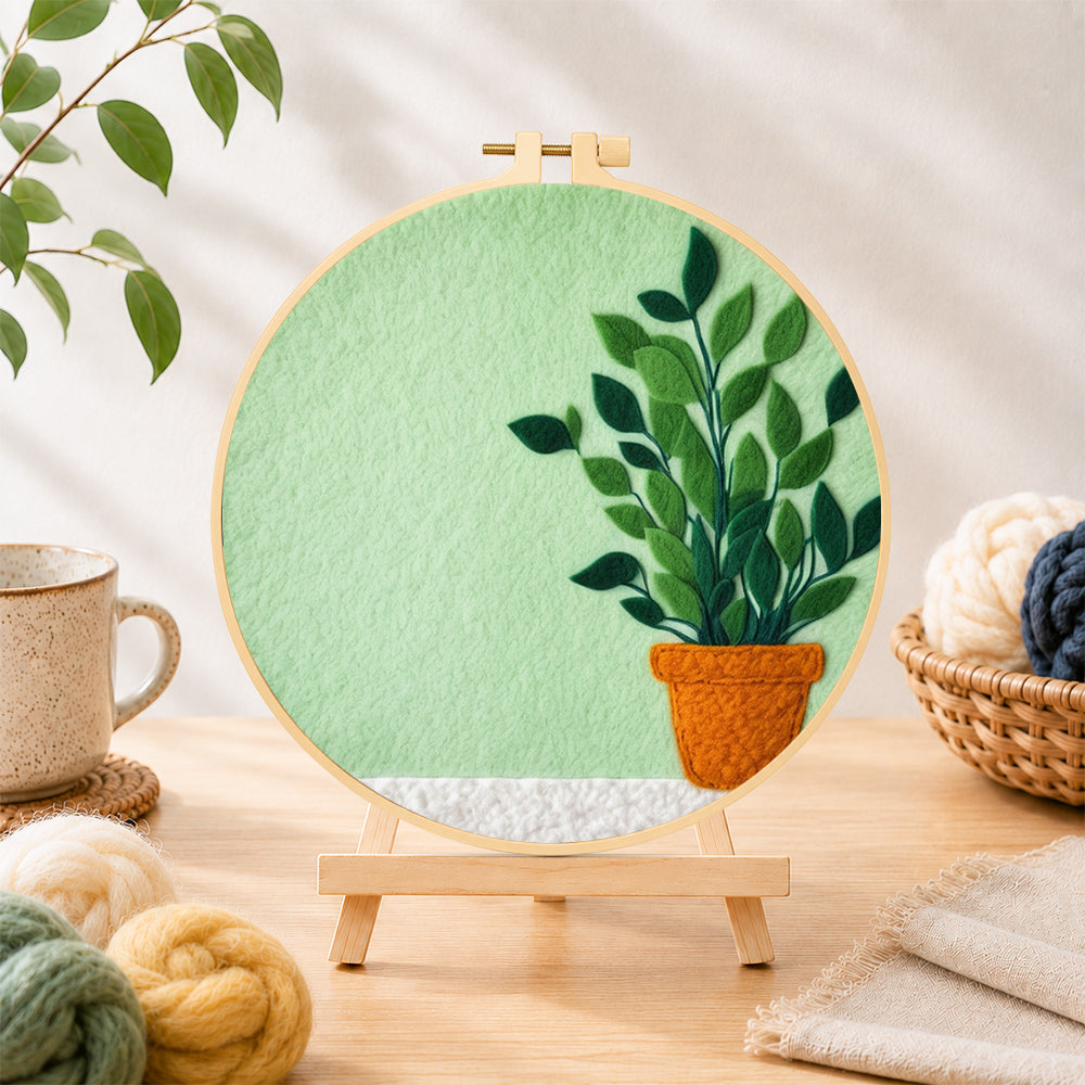 Finished potted plant on mint green needle felting displayed on a wooden easel