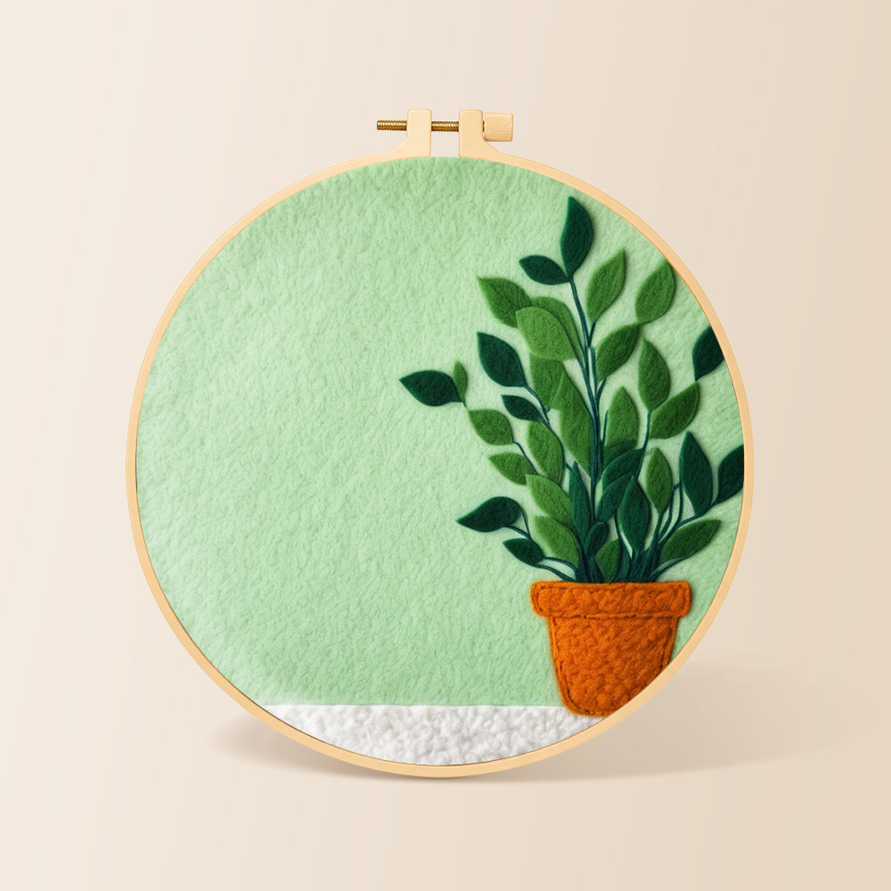 Potted plant on mint green needle felting kit for beginners with a round wooden frame