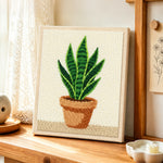 Potted snake plant punch needle artwork displayed on a table