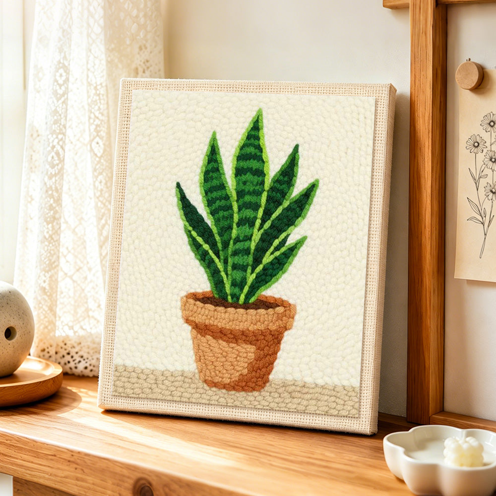 Potted snake plant punch needle artwork displayed on a table