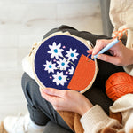 Creating handmade potted white flowers punch needle artwork
