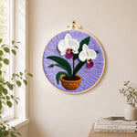 Potted white orchid needle felt wall art displayed in a bright home interior