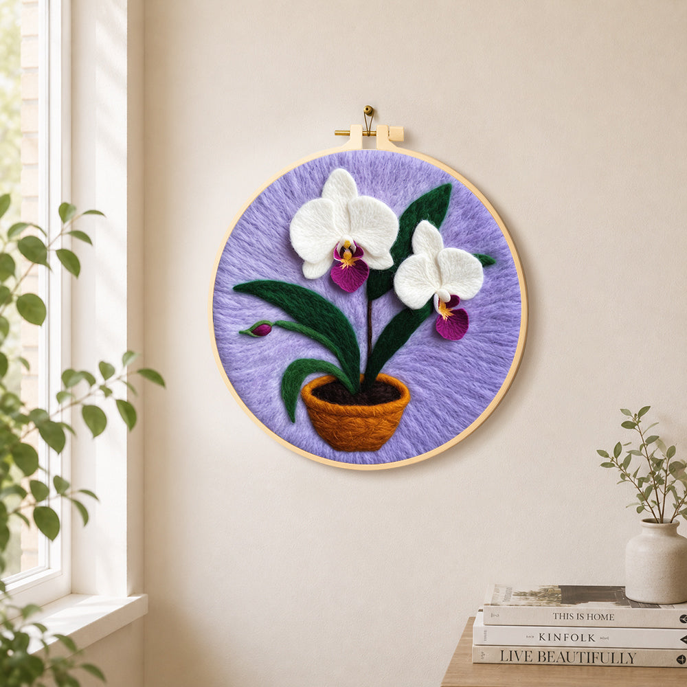 Potted white orchid needle felt wall art displayed in a bright home interior