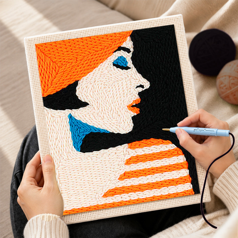 Creating handmade profile of woman in orange hat punch needle artwork