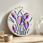 Purple and yellow tulip blooms punch needle artwork displayed on a table