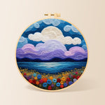 Purple clouds and flower-covered coastline needle felting kit for beginners with a round wooden frame