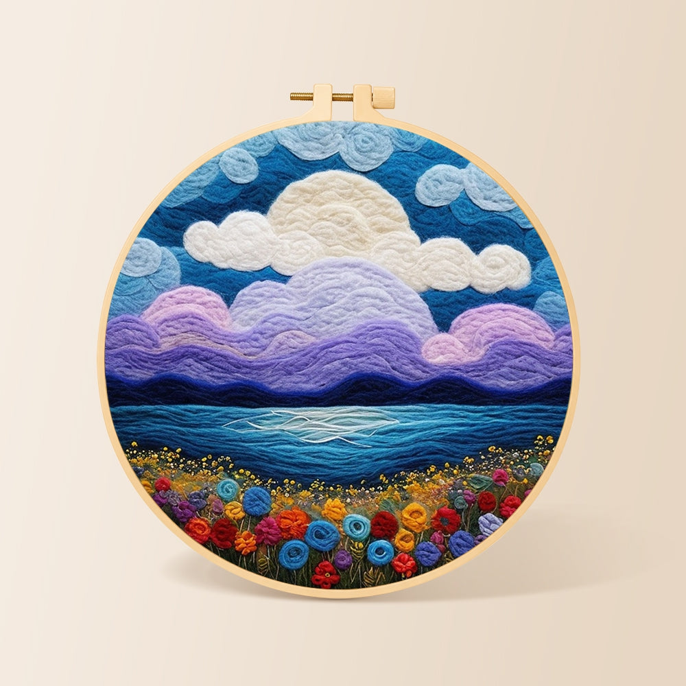 Purple clouds and flower-covered coastline needle felting kit for beginners with a round wooden frame