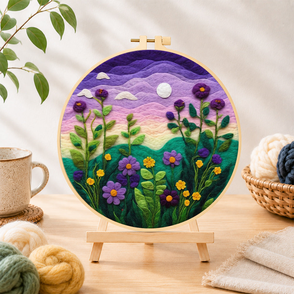 Finished purple dusk sky and tall wildflowers needle felting displayed on a wooden easel
