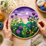 Creating the purple dusk sky and tall wildflowers wool painting by hand with a felting needle