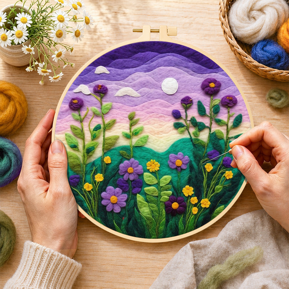 Creating the purple dusk sky and tall wildflowers wool painting by hand with a felting needle