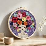 Purple floral crown girl punch needle artwork displayed on a table