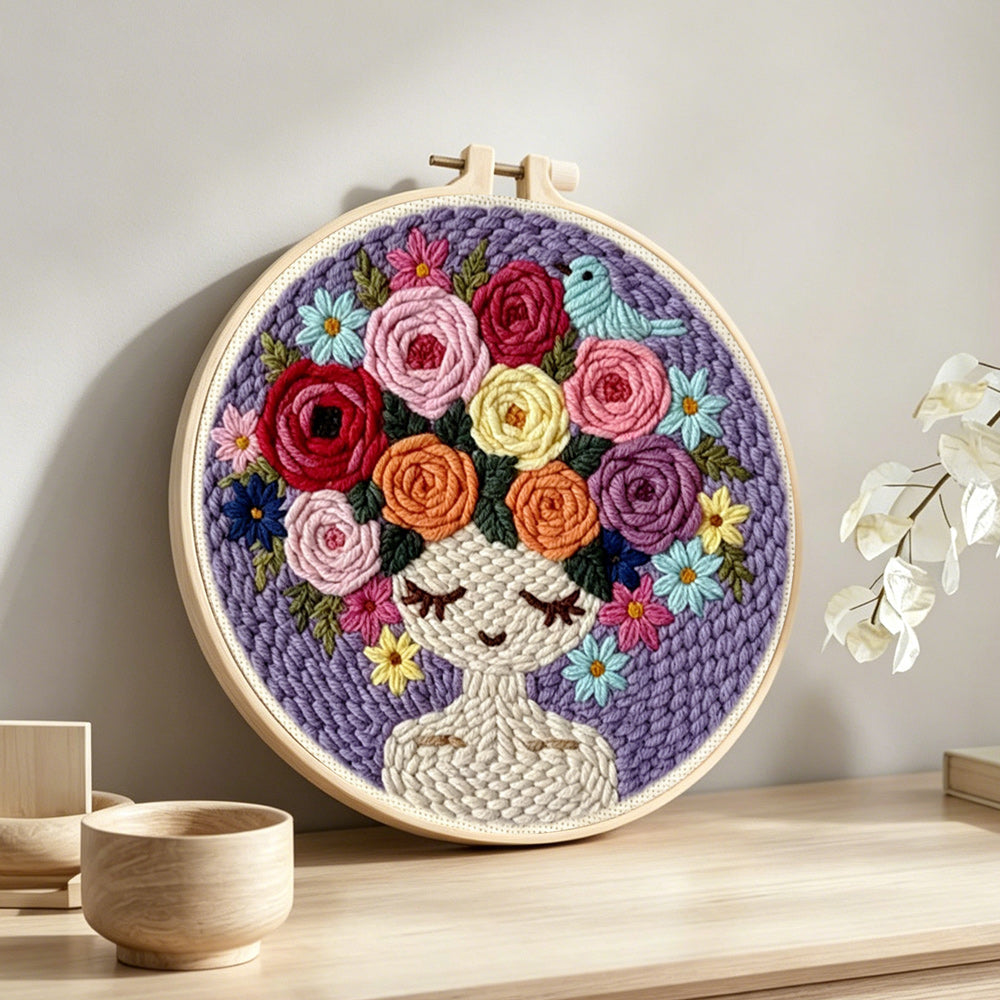 Purple floral crown girl punch needle artwork displayed on a table