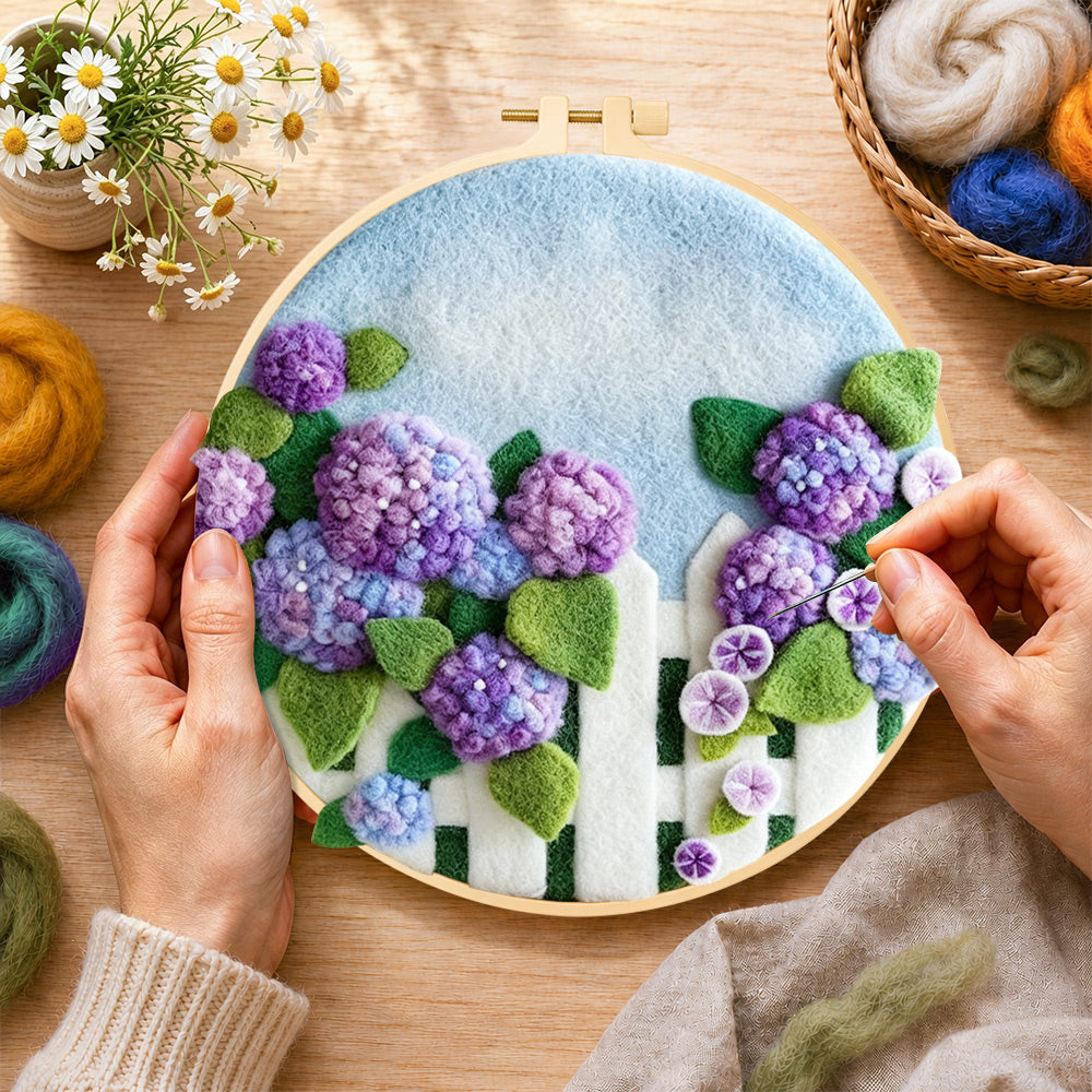 Creating the purple hydrangeas on fence wool painting by hand with a felting needle