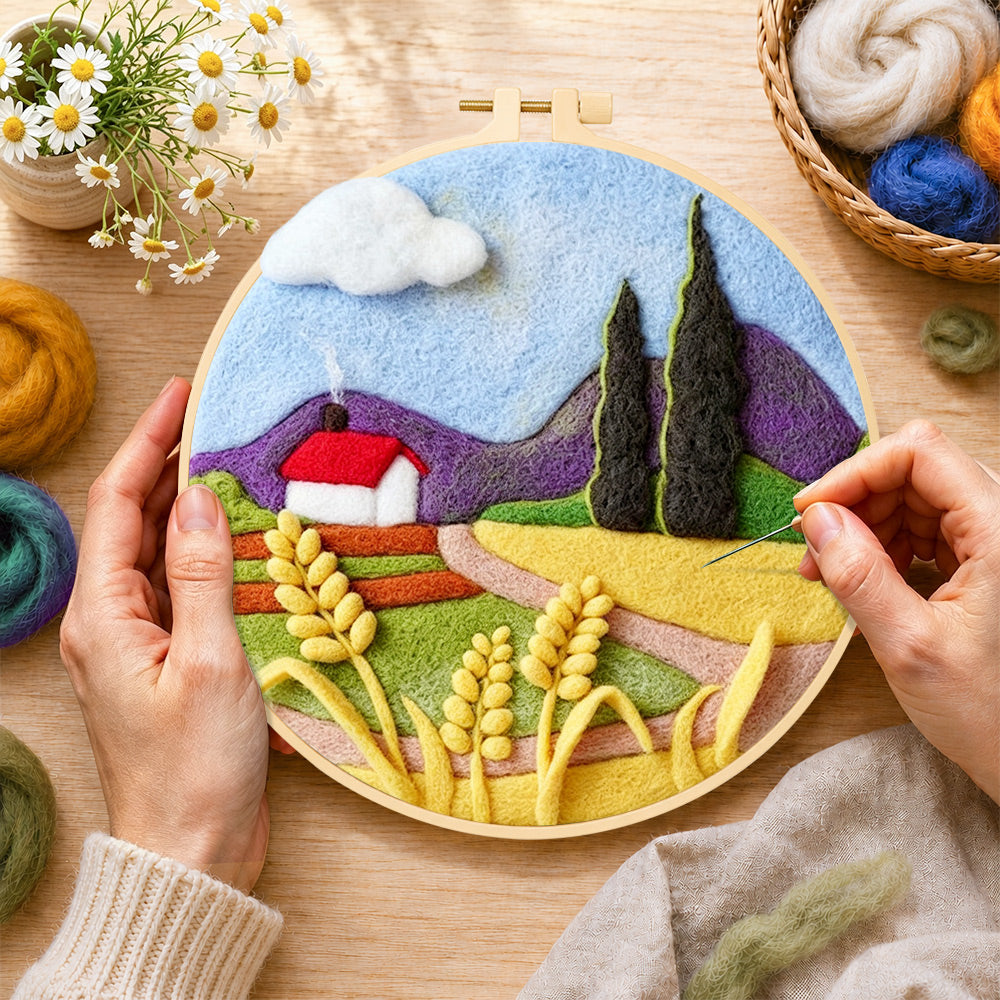 Creating the purple mountains and wheat cottage wool painting by hand with a felting needle