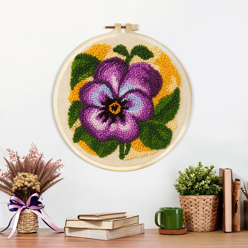 Finished purple pansy flower artwork displayed on a wall