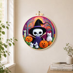 Purple skull witch with broom needle felt wall art displayed in a bright home interior