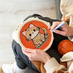 Creating handmade quiet little orange cat punch needle artwork