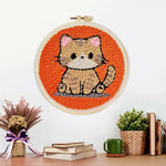 Finished quiet little orange cat artwork displayed on a wall