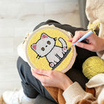 Creating handmade quiet little white cat punch needle artwork