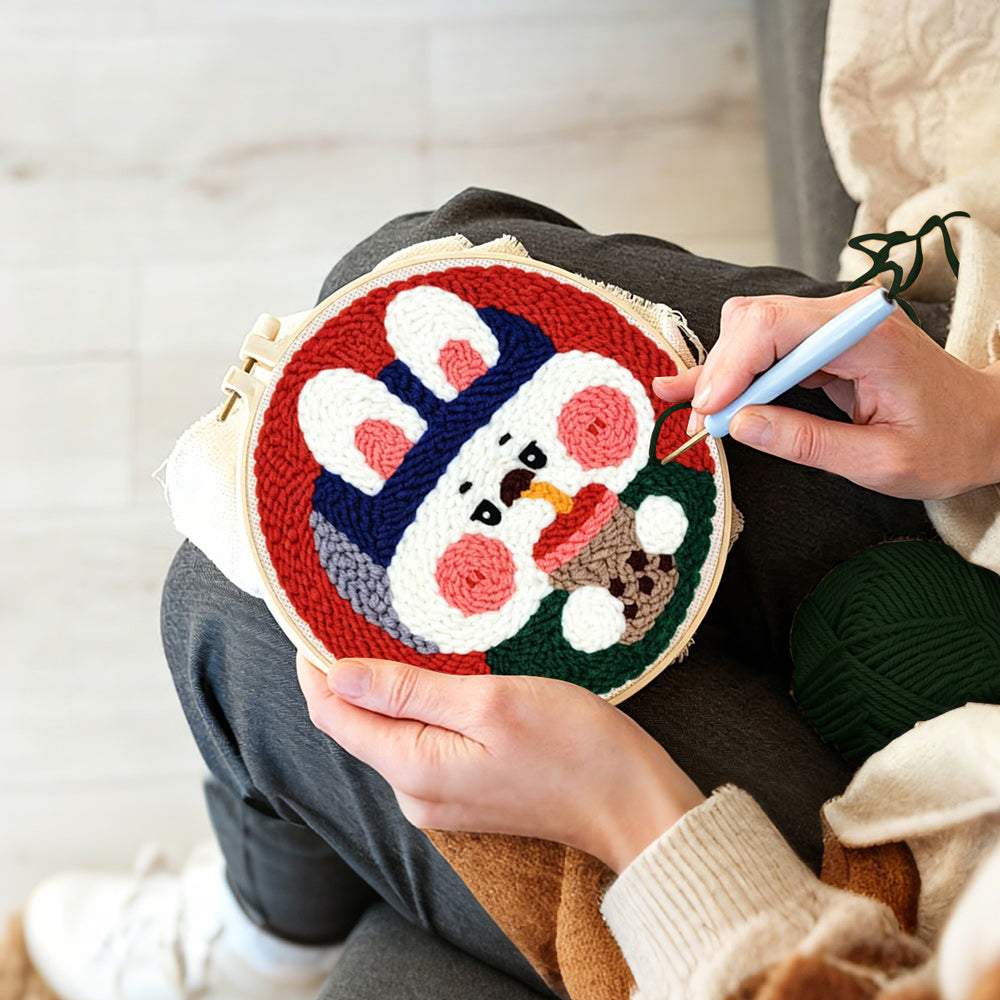 Creating handmade rabbit drinking bubble tea punch needle artwork
