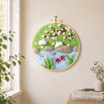Rabbits fishing under cherry blossoms needle felt wall art displayed in a bright home interior