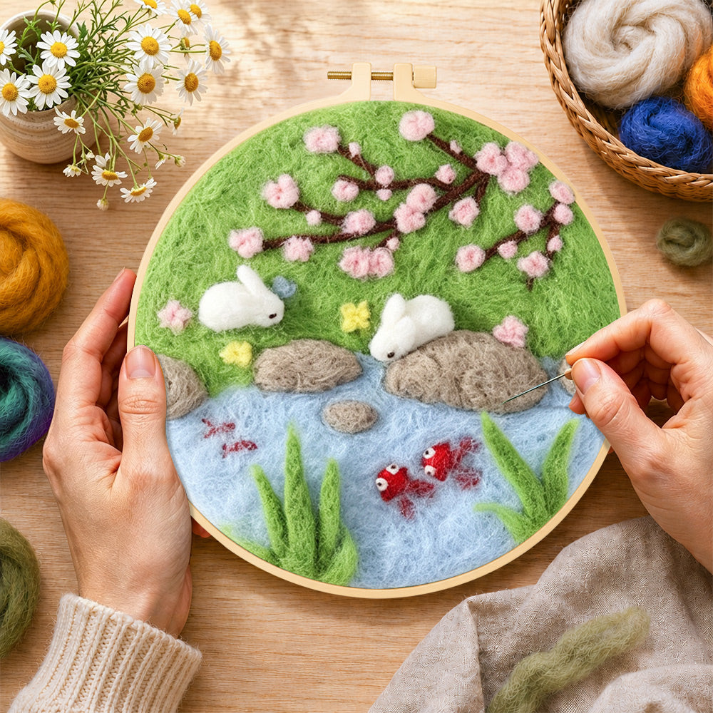 Creating the rabbits fishing under cherry blossoms wool painting by hand with a felting needle