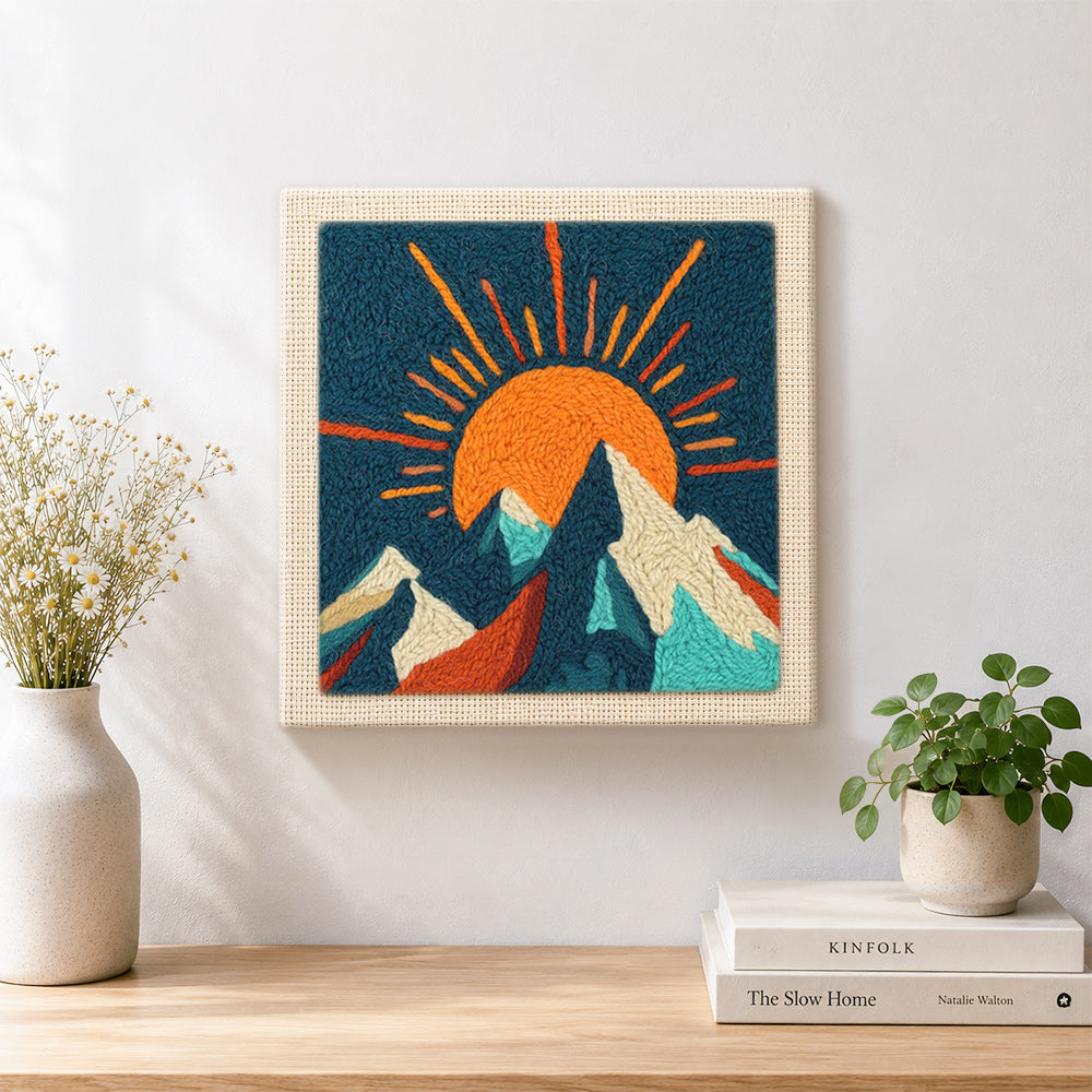 Finished radiant sunburst and snowy peaks artwork displayed on a wall