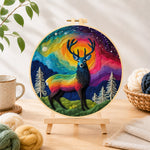 Finished rainbow aurora stag needle felting displayed on a wooden easel