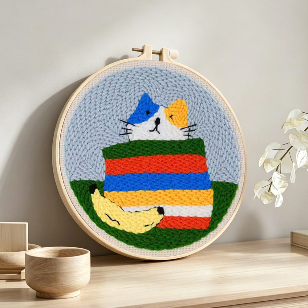Rainbow cat punch needle artwork displayed on a table