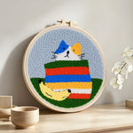 Rainbow cat punch needle artwork displayed on a table