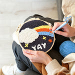 Creating handmade rainbow cloud and yay text punch needle artwork