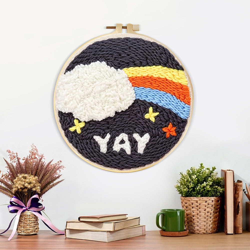 Finished rainbow cloud and yay text artwork displayed on a wall