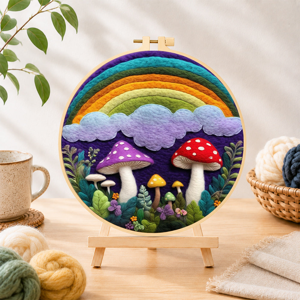 Finished rainbow, clouds and mushrooms needle felting displayed on a wooden easel