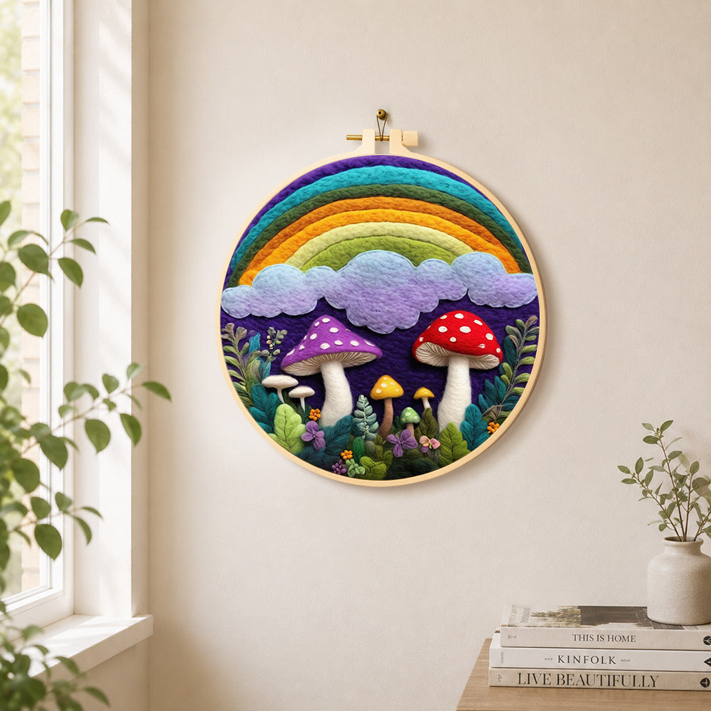 Rainbow, clouds and mushrooms needle felt wall art displayed in a bright home interior