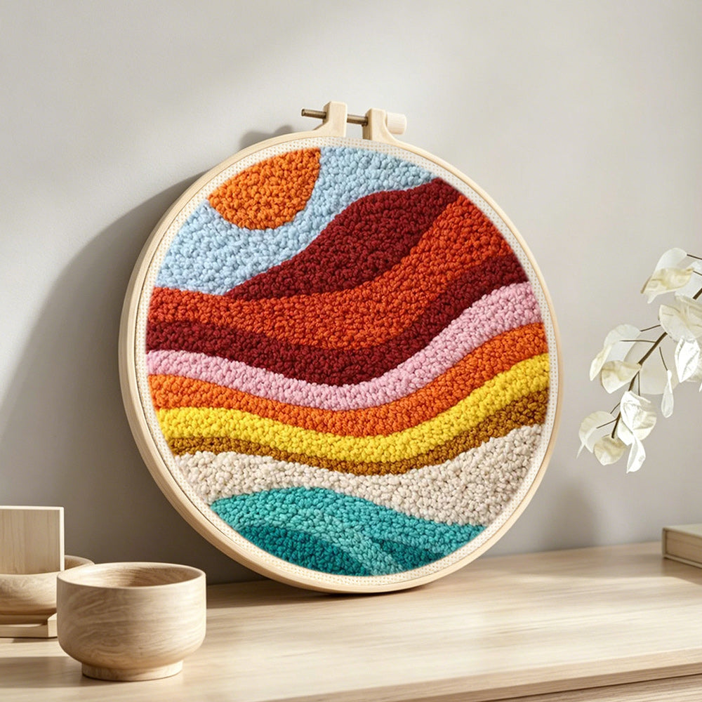Rainbow gradient mountains punch needle artwork displayed on a table