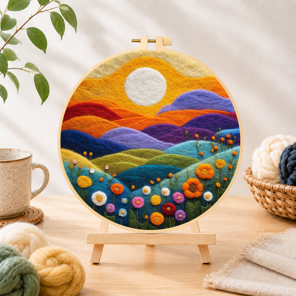 Finished rainbow hills with blooming flowers at sunset needle felting displayed on a wooden easel