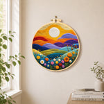 Rainbow hills with blooming flowers at sunset needle felt wall art displayed in a bright home interior