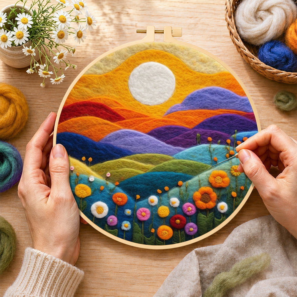 Creating the rainbow hills with blooming flowers at sunset wool painting by hand with a felting needle