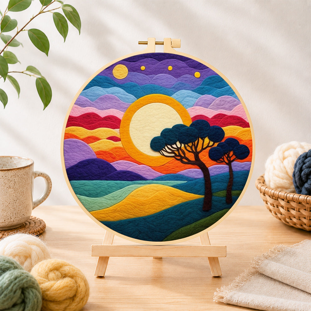 Finished rainbow layered clouds and savannah trees needle felting displayed on a wooden easel
