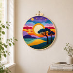 Rainbow layered clouds and savannah trees needle felt wall art displayed in a bright home interior