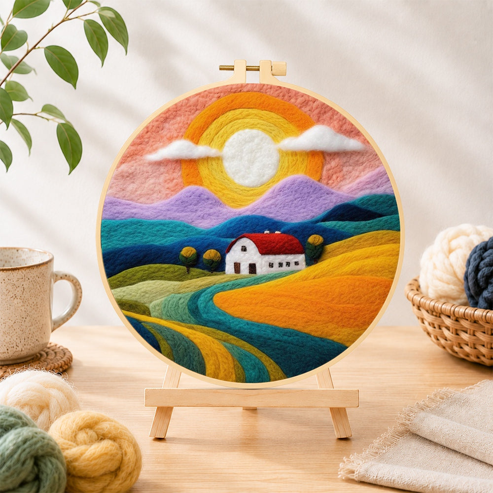 Finished rainbow mountains at sunset needle felting displayed on a wooden easel