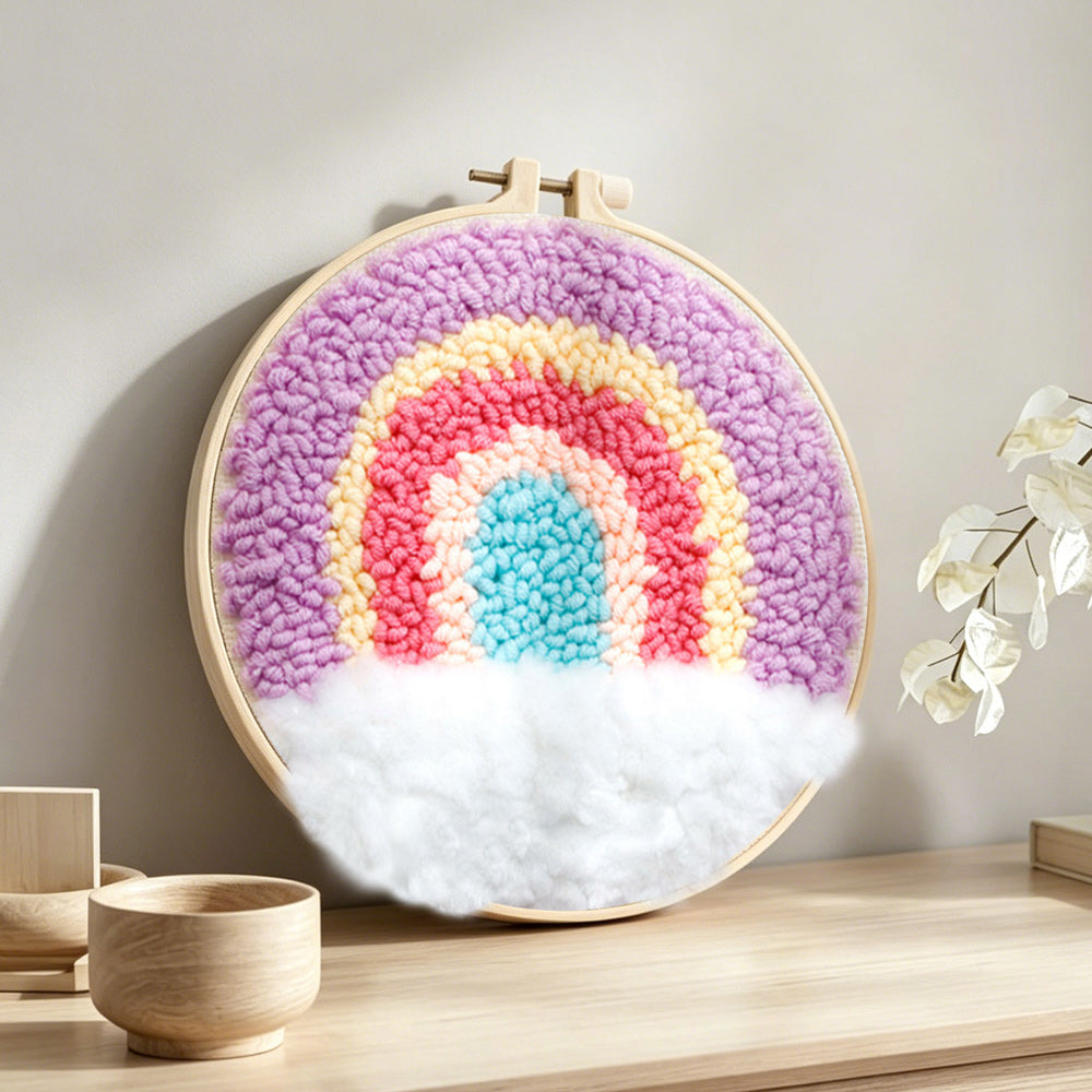 Rainbow over clouds punch needle artwork displayed on a table