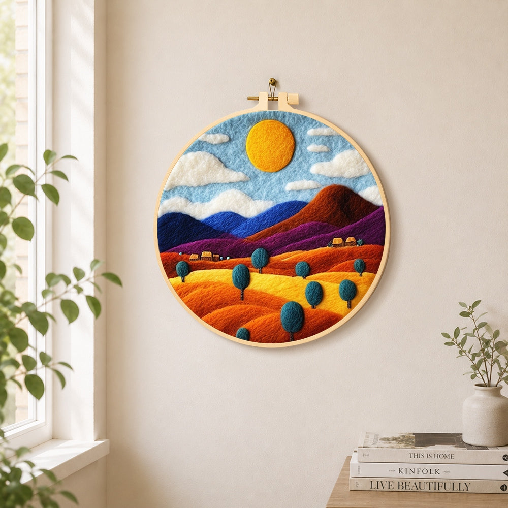 Rainbow wheat fields and mountains needle felt wall art displayed in a bright home interior
