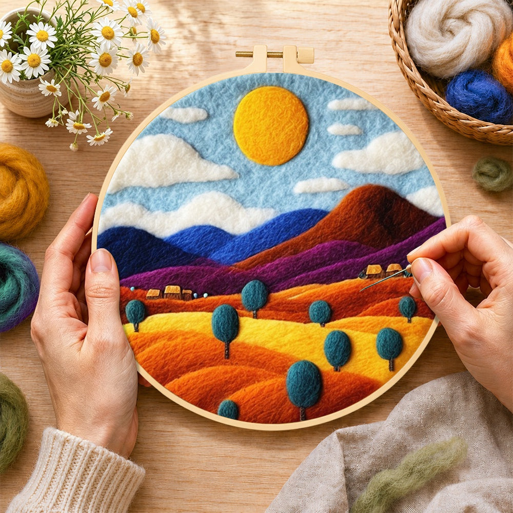 Creating the rainbow wheat fields and mountains wool painting by hand with a felting needle