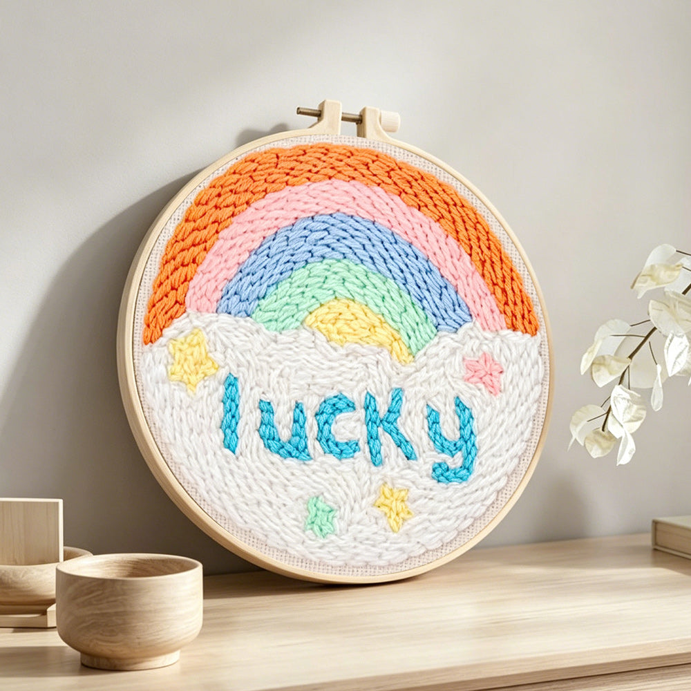 Rainbow with lucky text punch needle artwork displayed on a table