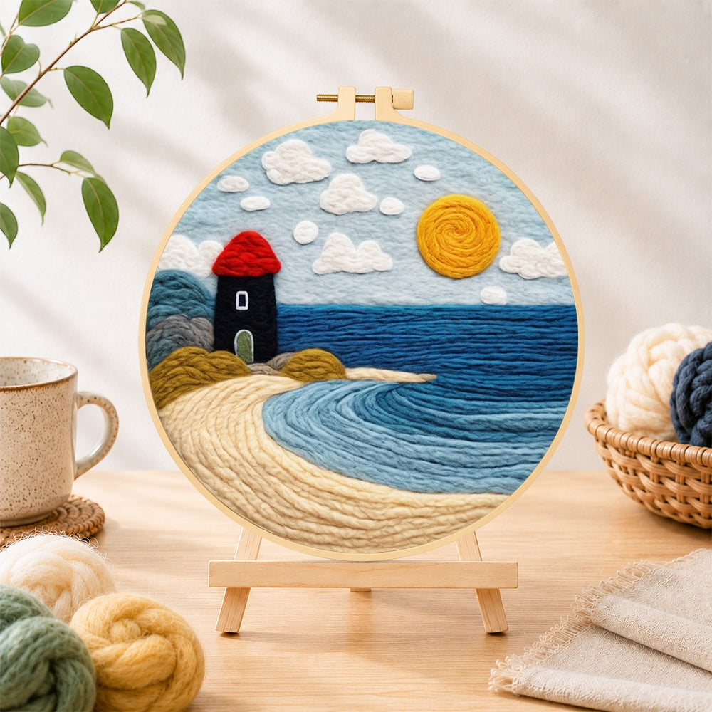 Finished red and black lighthouse by the sea needle felting displayed on a wooden easel