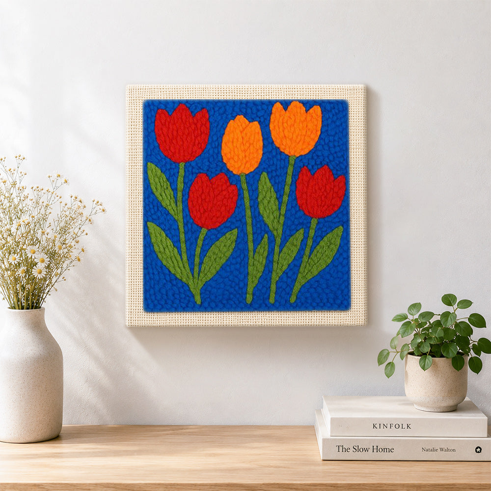 Finished red and orange tulip flowers artwork displayed on a wall